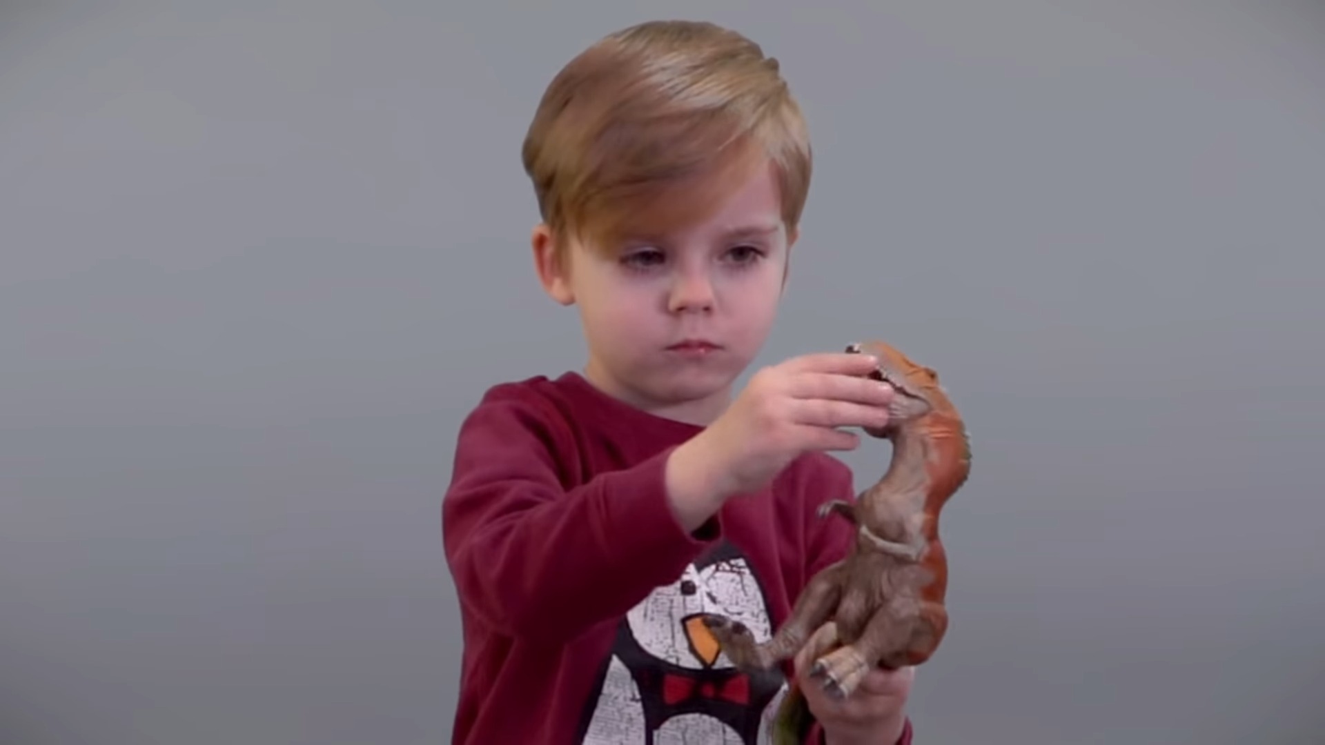 Boy Playing With a Dinosaur